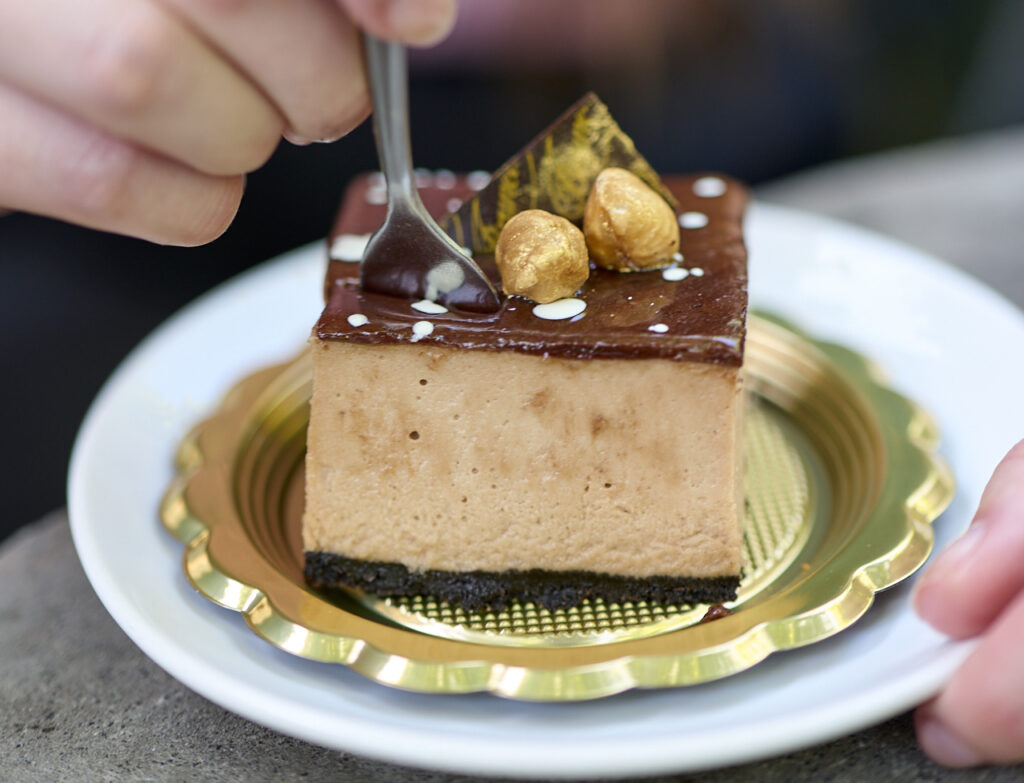 Fork scooping into a slice of nutella cheesecake