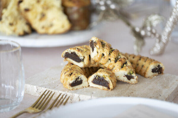 Close-up of traditional Christmas pastries filled with fig, pistachios and marsala.